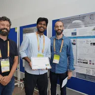 Aditya Kumar holding a Best Poster Award certificate at JEMS 2025, standing beside his poster on exchange bias in van der Waals heterostructures.
