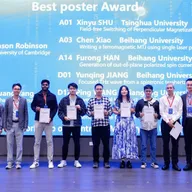 Aditya Kumar and eight other researchers holding best-poster-award certificates on stage at the 2024 Spintronic Memory and Logic workshop in Hangzhou, in front of a screen listing the winning posters.