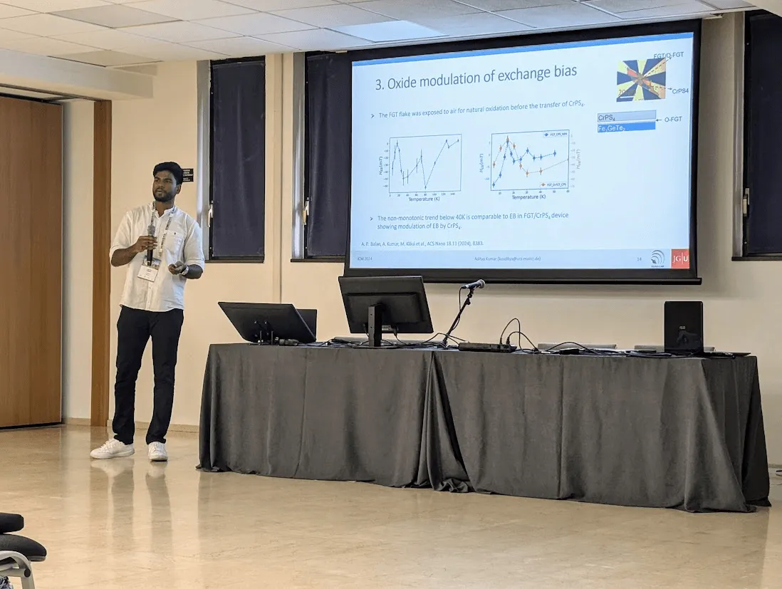 Aditya Kumar presenting an invited talk at the International Conference on Magnetism (ICM) 2024 in Bologna, with a slide on oxide modulation of exchange bias.